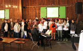 Der ökumenische und integrative Chor der Gelsenkirchener Werkstätten unter Leitung von Dieter Lattek ergänzte den Pfingstmontags-Gottesdienst unter der Remise von Hof Holz.