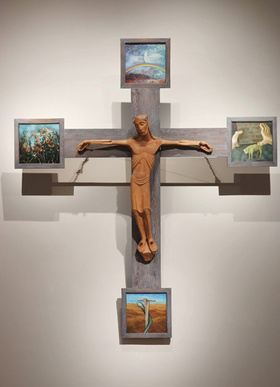 Das Kreuz trägt an den Enden Bildtafeln mit Motiven aus dem Alten Testament.